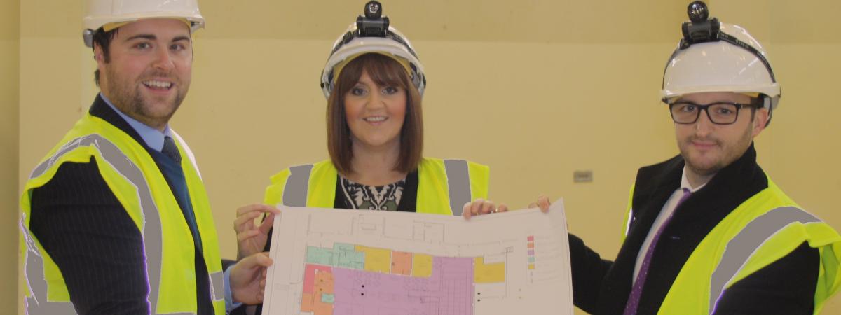 Image 1 – Noel Rooney, Ortus Property Development Executive, Catherine McClelland, Roar and Explore Project Manager and Conor Smith, Housing Executive System Manager Social Investment Team with the plans for Roar and Explore