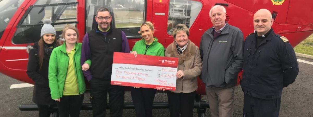 Air Ambulance NI Pilot Allan Bryers accepts a donation from Hillmount owners Robin and Edith Mercer and staff Courtney Best, Ashley Brown, David Proctor and Naomi Ferguson.