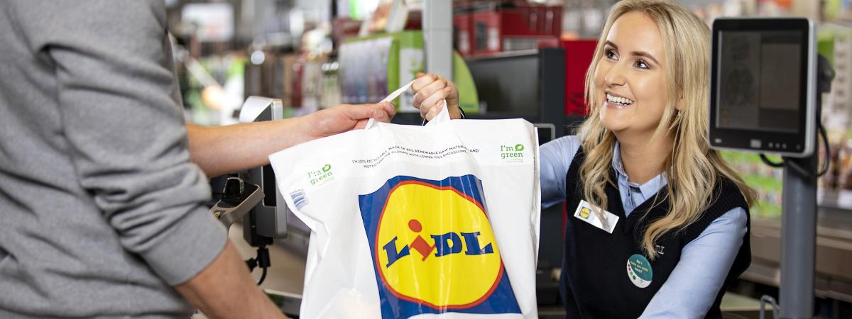 Woman handing a Lidl bag to a customer