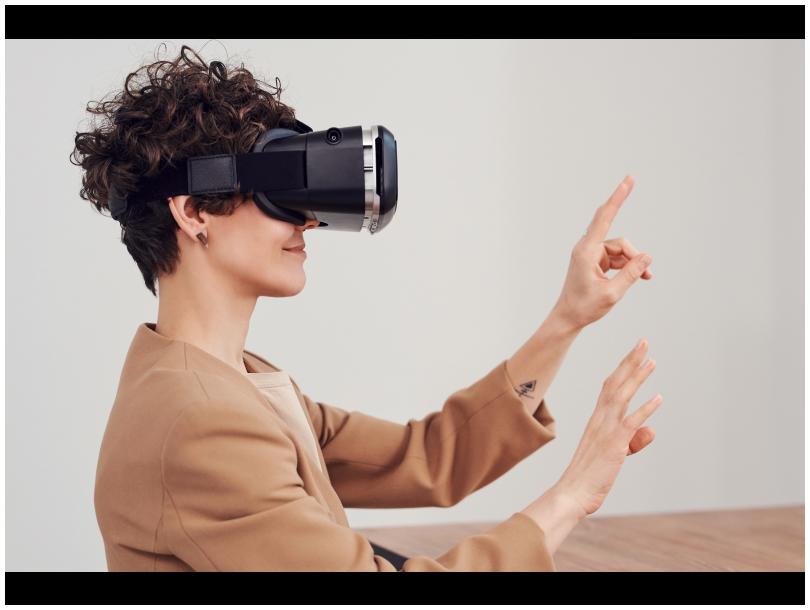 Smiling woman using a VR headset.