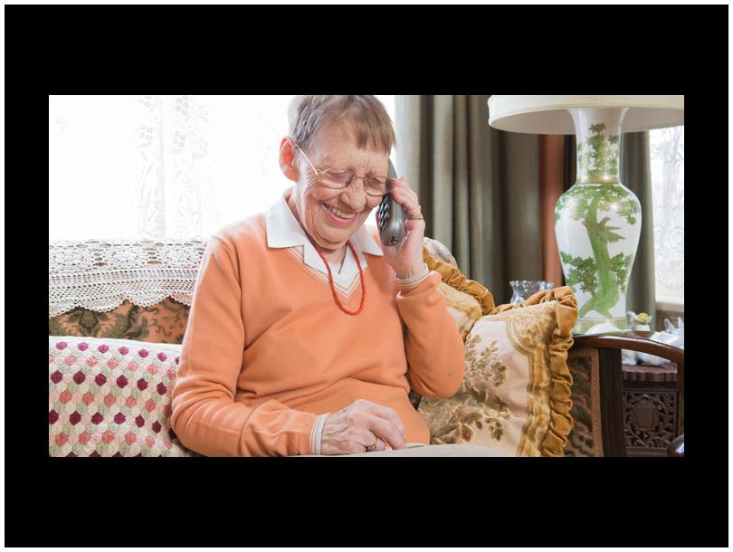 this is an image of an older lady talking and smiling on the phone