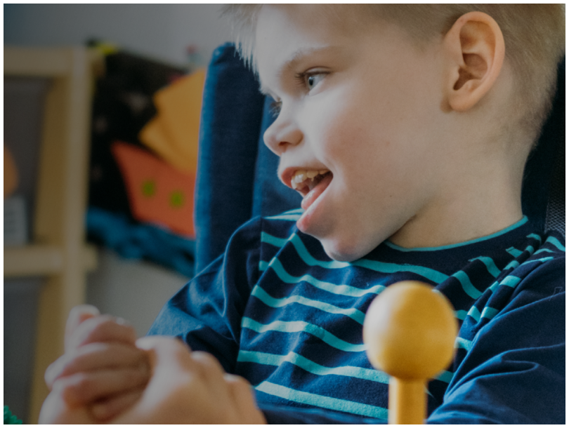 An image of young disable boy in a chair and text saying 'Advocating on behalf of children in need'