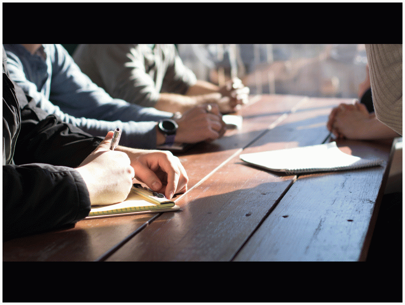 Image of people sitting around a table.