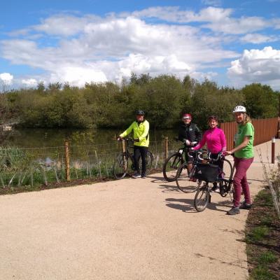  Forth Meadow Community Greenway volunteers standing with their bikes in front of bridge at Springfield Dam as they take part in cycle training